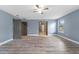 Bright bedroom with hardwood floors, gray accent wall, and natural light from a window at 11006 Tahiti Isle Ln, Tampa, FL 33647