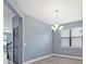 Dining area with a modern chandelier, neutral paint, and an outside view at 11006 Tahiti Isle Ln, Tampa, FL 33647