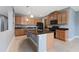 This kitchen has granite countertops, an island, tile floors, and stainless steel appliances at 11006 Tahiti Isle Ln, Tampa, FL 33647