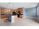 Kitchen with wood cabinetry, granite countertops, tile floors, and stainless steel appliances at 11006 Tahiti Isle Ln, Tampa, FL 33647