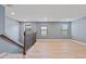 Bright living room features beautiful light wood floors and natural light from three large windows at 11006 Tahiti Isle Ln, Tampa, FL 33647