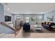 Stylishly decorated living room with blue couches, grey rug, and copper railing near stairs at 11006 Tahiti Isle Ln, Tampa, FL 33647