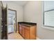 Mud room with granite countertop and storage cabinets leads to garage at 11006 Tahiti Isle Ln, Tampa, FL 33647