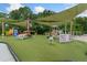Outdoor playground features a soft turf, shade covers and various play structures at 11006 Tahiti Isle Ln, Tampa, FL 33647