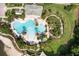 Aerial view of a resort-style pool with ample seating and lush landscaping at 11006 Tahiti Isle Ln, Tampa, FL 33647