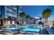Outdoor pool area at night with a large pool, palm trees, lounge chairs, and a concert stage at 1101 E Jackson St # 2302, Tampa, FL 33602