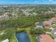 An aerial view of the property showing the scenic neighborhood and pond at 1171 Red Maple Ne Cir, St Petersburg, FL 33703