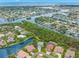 Stunning aerial view of waterfront homes and waterways, showcasing lush landscaping and coastal living at 1171 Red Maple Ne Cir, St Petersburg, FL 33703