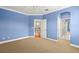 Spacious bedroom with a view of the staircase and hallway through open doorways at 1171 Red Maple Ne Cir, St Petersburg, FL 33703