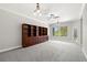 Spacious bonus room with built-in shelving, neutral carpet and a ceiling fan at 1171 Red Maple Ne Cir, St Petersburg, FL 33703