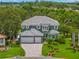 Charming two-story home with a three-car garage, manicured lawn, and lush landscaping at 1171 Red Maple Ne Cir, St Petersburg, FL 33703