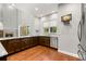 Modern kitchen featuring granite counters, stainless steel appliances, and beautiful hardwood floors at 1171 Red Maple Ne Cir, St Petersburg, FL 33703