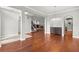 Spacious living room with hardwood floors, an elegant staircase, and a cozy fireplace at 1171 Red Maple Ne Cir, St Petersburg, FL 33703