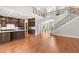 Open-concept living area with hardwood floors, staircase, and modern kitchen at 1171 Red Maple Ne Cir, St Petersburg, FL 33703