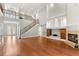 Elegant living room with hardwood floors, staircase, and built-in shelves at 1171 Red Maple Ne Cir, St Petersburg, FL 33703