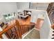 Open concept living room showcasing hardwood floors, fireplace, kitchen view, and grand staircase at 1171 Red Maple Ne Cir, St Petersburg, FL 33703