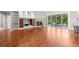 Bright and airy living room featuring a fireplace, hardwood floors, and sliding glass doors to the outside at 1171 Red Maple Ne Cir, St Petersburg, FL 33703