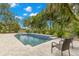 Beautiful pool with spa surrounded by lush tropical landscaping at 1171 Red Maple Ne Cir, St Petersburg, FL 33703