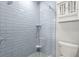 Bathroom shower featuring a tiled wall and glass door at 1171 Red Maple Ne Cir, St Petersburg, FL 33703