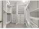 Well-organized walk-in closet featuring built-in shelving, drawers, and ample storage space at 1171 Red Maple Ne Cir, St Petersburg, FL 33703