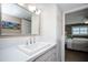 Bathroom features a vanity with drawers, a large mirror and view into main bedroom at 12300 Park Blvd # 222, Seminole, FL 33772