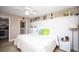 Relaxing bedroom featuring a large bed, white wainscotting, and ceiling fan at 12300 Park Blvd # 222, Seminole, FL 33772