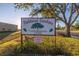 Oakhurst Gardens Condominium sign with mature tree and landscaping at community entrance at 12300 Park Blvd # 222, Seminole, FL 33772