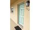Close-up of the unit front door with a small window and light fixture at 12300 Park Blvd # 222, Seminole, FL 33772