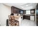 Charming kitchen featuring dark wood cabinets, tile floors, and an eat-in breakfast bar at 12300 Park Blvd # 222, Seminole, FL 33772