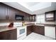Bright kitchen features stainless steel appliances and stylish, dark wood cabinets and granite countertops at 12300 Park Blvd # 222, Seminole, FL 33772