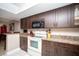 Modern kitchen featuring stainless steel appliances, rich wood cabinetry, and granite countertops at 12300 Park Blvd # 222, Seminole, FL 33772
