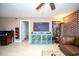 View of a well-decorated living room featuring a ceiling fan, brick accent wall, and sectional sofa at 12300 Park Blvd # 222, Seminole, FL 33772