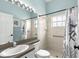 Tiled bathroom featuring a shower, modern fixtures, and updated vanity at 12339 Roseland Dr, New Port Richey, FL 34654