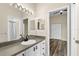 This bathroom features a vanity with a sink, a large mirror, and an open doorway to another room at 12339 Roseland Dr, New Port Richey, FL 34654