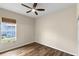 This bedroom features hardwood floors and natural light from one window at 12339 Roseland Dr, New Port Richey, FL 34654