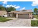 Inviting single-story home with a spacious two-car garage and beautifully landscaped front yard at 12339 Roseland Dr, New Port Richey, FL 34654