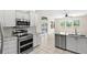 Modern kitchen with stainless steel appliances, granite countertops, and an open layout to the backyard at 12339 Roseland Dr, New Port Richey, FL 34654