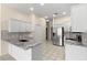 Well-lit kitchen with granite countertops, stainless steel appliances, and ample cabinet space at 12339 Roseland Dr, New Port Richey, FL 34654