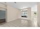 Spacious living area with tile flooring and large windows, offering views of the serene lake at 12339 Roseland Dr, New Port Richey, FL 34654