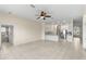 Open concept living area features tile flooring, ceiling fan and views of the modern kitchen at 12339 Roseland Dr, New Port Richey, FL 34654