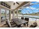 Screened patio with outdoor dining area overlooks the pool and peaceful lake at 12339 Roseland Dr, New Port Richey, FL 34654