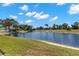 Expansive backyard pond view showcases the tranquil setting of this lushly landscaped home at 12339 Roseland Dr, New Port Richey, FL 34654