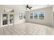 Bright sunroom with tile floors and numerous windows offering views of the tranquil water feature at 12339 Roseland Dr, New Port Richey, FL 34654
