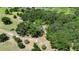 Secluded property with mature trees and lush landscaping surrounded by ponds and agricultural land at 12434 Cody Dr, Wimauma, FL 33598