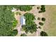 Aerial view of the house with white roof surrounded by trees and grass at 12434 Cody Dr, Wimauma, FL 33598