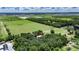 Aerial view of the property shows ample land, mature trees, and a glimpse of the home's roof at 12434 Cody Dr, Wimauma, FL 33598