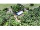 Aerial view of a secluded home surrounded by lush trees and greenery at 12434 Cody Dr, Wimauma, FL 33598