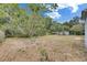 Spacious backyard area with a mix of sun and shade, with views of wooded areas at 12434 Cody Dr, Wimauma, FL 33598