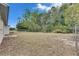Large backyard with fenced boundary, offering privacy and room for outdoor activities at 12434 Cody Dr, Wimauma, FL 33598