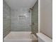 Modern bathroom features a shower with a niche and stylish gray subway tile surround at 12434 Cody Dr, Wimauma, FL 33598